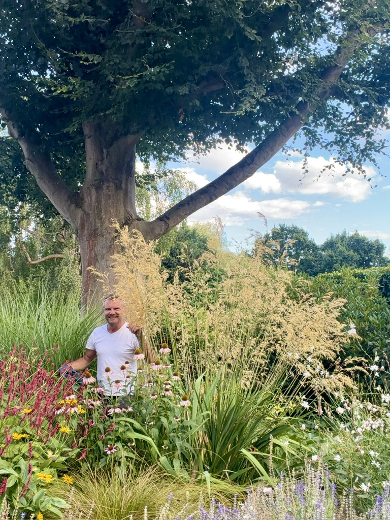 Michael Pooley among the planting in a mature English garden