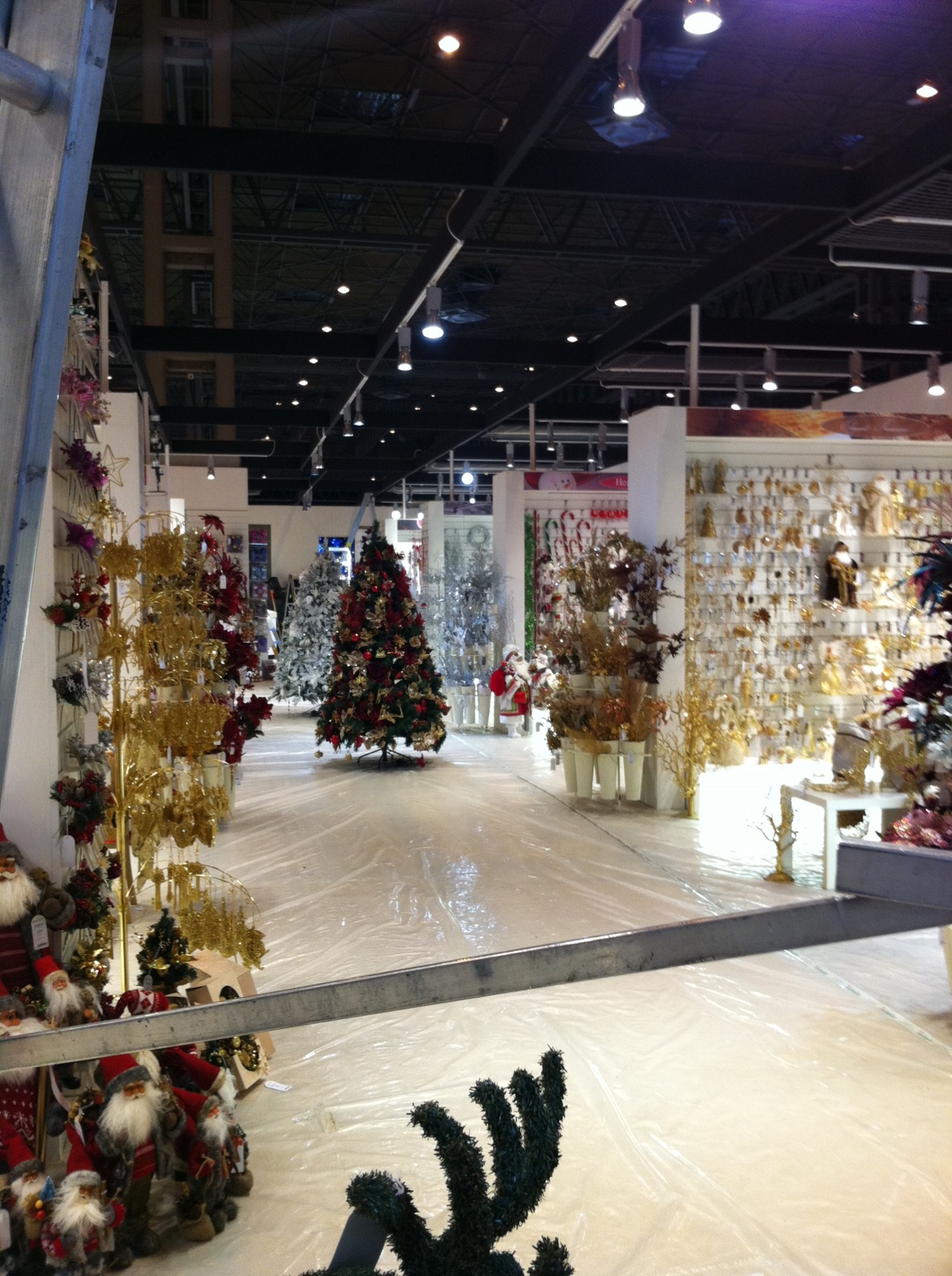 A large seasonal showroom with decorated Christmas trees and coordinated displays of ornaments